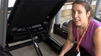 Team member Rachael taking a closer look at Horizon Fitness treadmills.