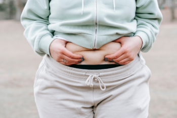 woman holding her belly fat